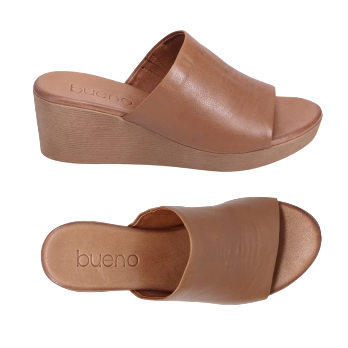 Pair of Brown slide sandals with brown wedge outsole and tan Bueno logo'd footbed.