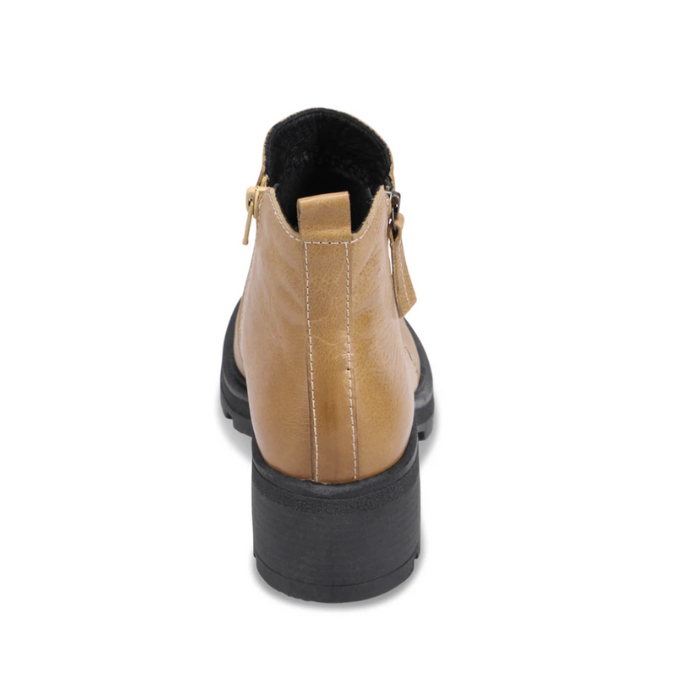 Heel of Yellow ankle boot with dual side zippers, pull tab and black lugged outsole