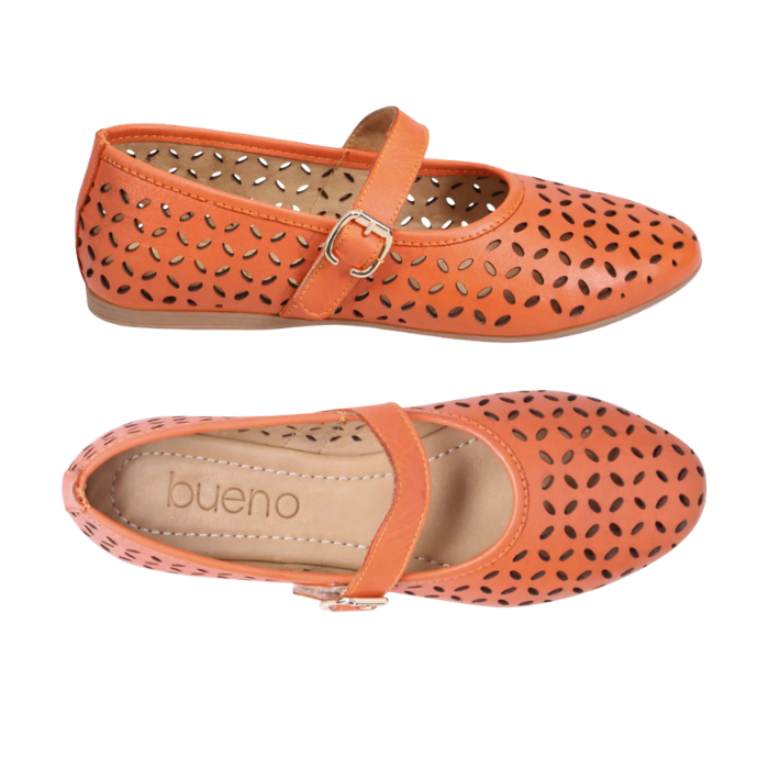 Pair of Mary Jane Flat in orange leather with floral laser-cut design, Velcro strap, tan Bueno footbed and tan outsole.