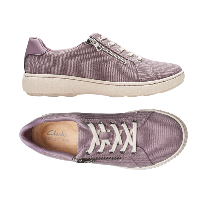 Pair of Purple canvas sneakers with white laces, side zipper, tan Clarks footbed and white outsole.