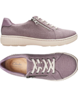 Pair of Purple canvas sneakers with white laces, side zipper, tan Clarks footbed and white outsole.