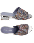 Top and side views of Django & Juliette Tammy heeled slide sandal in silver, showcasing intricate beadwork and cushioned footbed for comfort.