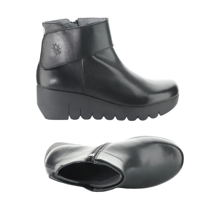 Pair of A black leather ankle boots with a chunky platform outsole, inside zipper and a wide strap across the ankle.