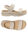 Pair of Beige sandals with toe, vamp and back elastic straps, tan footbed and platform outsole.