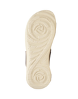 Beige treaded outsole of sandal with Merrell logo stamped in toe. Tread resembles two rose buds.