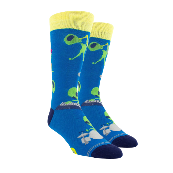 Blue socks with aliens playing instruments, yellow cuff and dark navy heel and toe cap.