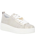 Dusted gold sneaker with white laces, gold dragonfly lace charm and white platform outsole.