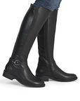 Black knee-high boots with a buckle on ankle worn with blue jeans.