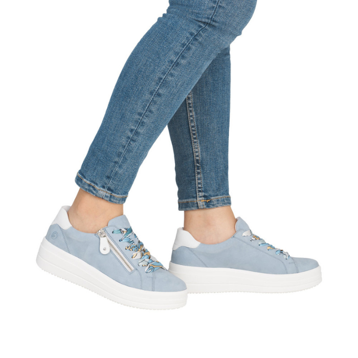 Light blue platform sneakers worn with blue jeans.