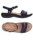 Pair of Navy strappy sandals with gold circle buckle detail, tan Revere logo'd footbed and black outsole.
