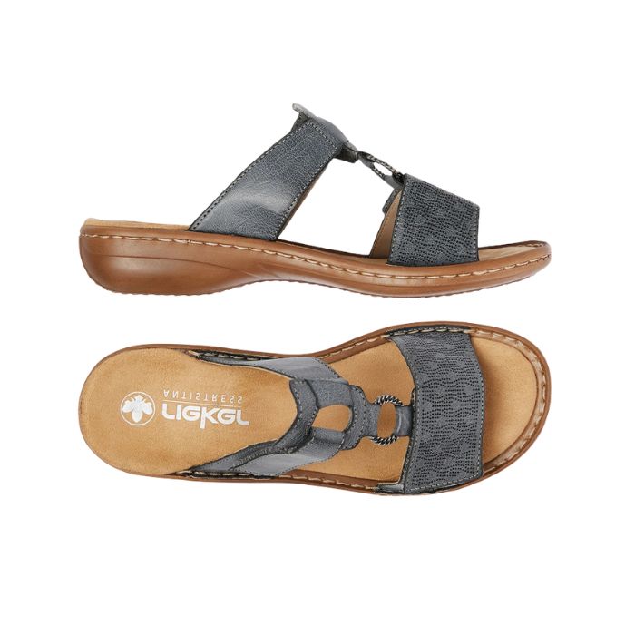 Pair of blue slide sandal with two Velcro straps, textured details and medallion accent, tan Rieker logo'd footbed and brown outsole.