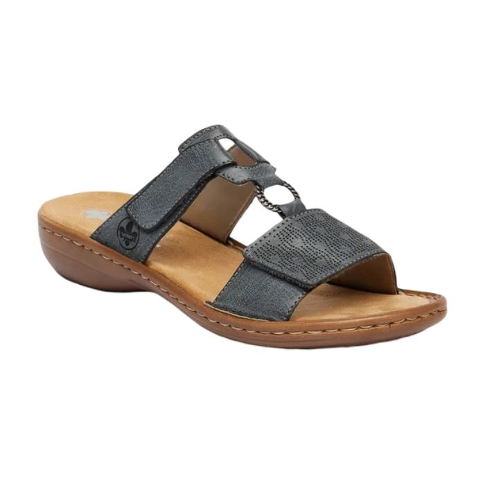 Blue slide sandal with two Velcro straps, textured details and medallion accent, tan Rieker logo'd footbed and brown outsole.