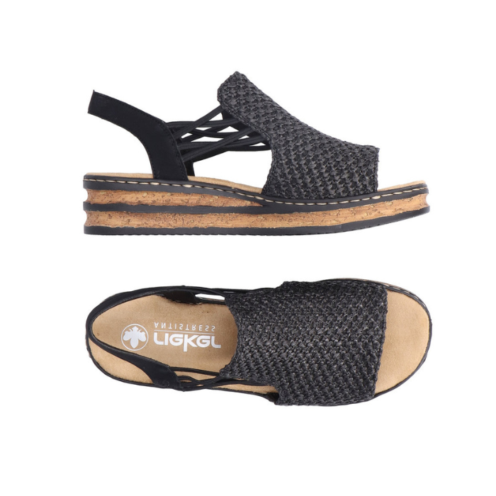 Pair of Black woven sandals with faux cork midesole, thin elastic side straps, backstrap and tan Rieker logo'd footbed