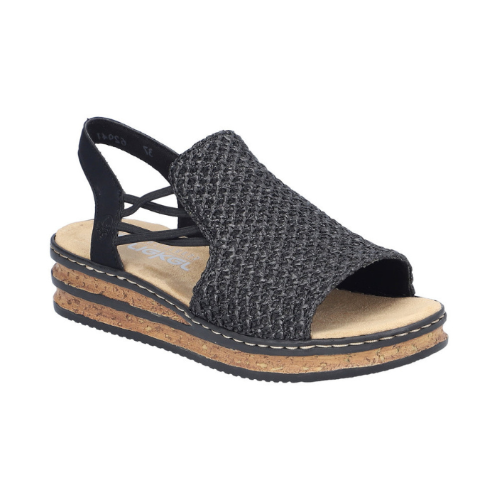 Black woven sandal with faux cork midesole, thin elastic side straps, backstrap and tan Rieker logo'd footbed.