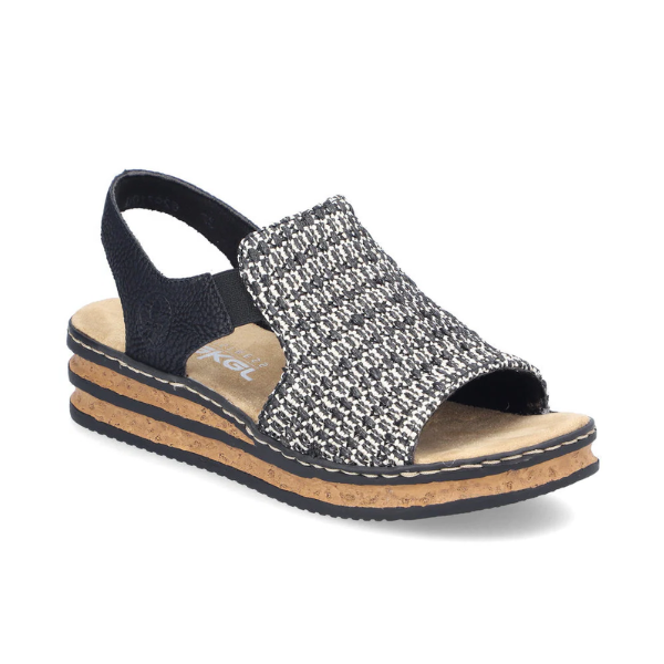 Backstrap Sandal with a black and white woven upper, side elastics, tan Rieker logo'd footbed, and faux cork midsole with black layers.