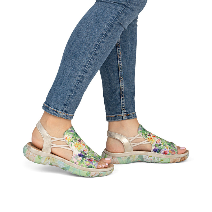 Green Floral sandals worn with blue jeans.