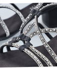 Close up of sandals straps showing diamonds and pearl details.