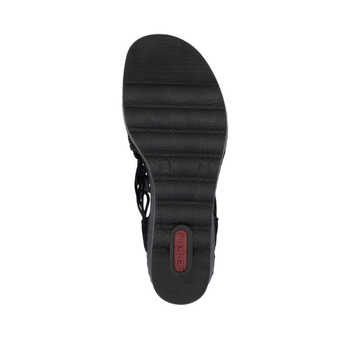 Black light treaded outsole of wedge sandal with red Rieker logo on heel.