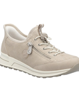 Beige sneaker with white bungee lacing, pale shimmery wording accents over upper and a grey outsole.