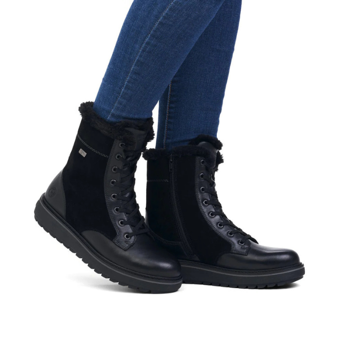 Black boots with fur lining worn with blue jeans.