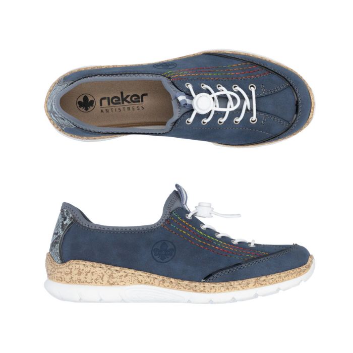 Pair of navy blue slip on sneaker with rainbow side accent rainbow stitching, white bungie closure and faux cork midsole and white outsole. 