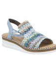 Wedge backstrap sandal in blue with green, beige and gold woven into the upper, elastic sides and white outsole.