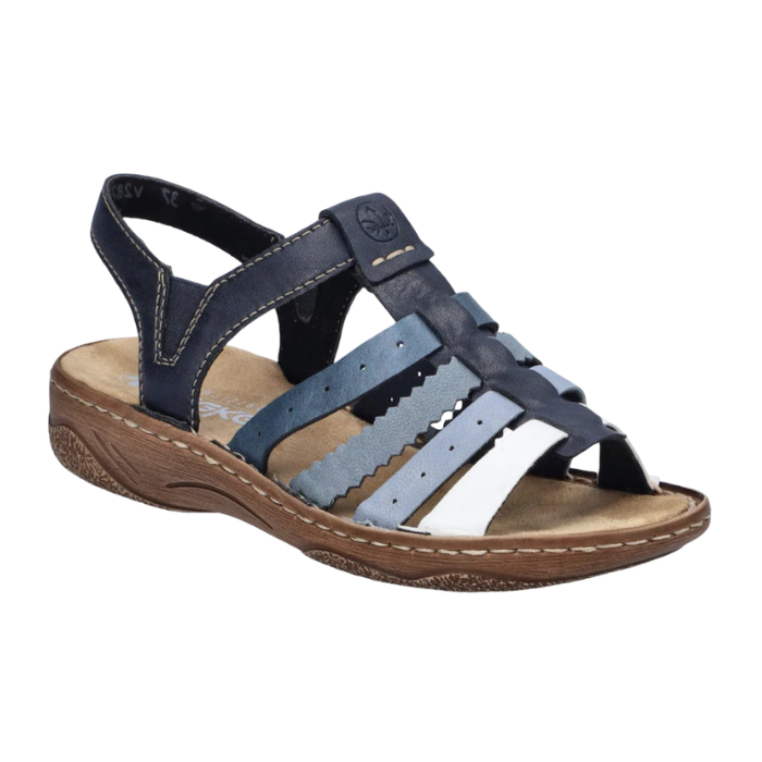 Navy blue sandal with fading lighter blue straps, gladiator style upper, tan Rieker logo'd footbed and brown outsole.
