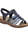 Navy blue sandal with fading lighter blue straps, gladiator style upper, tan Rieker logo'd footbed and brown outsole.