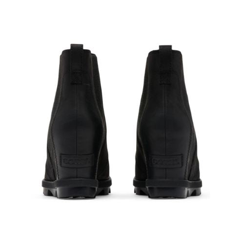 Heels of black wedge Chelsea boot with Sorel logo stamped at base.