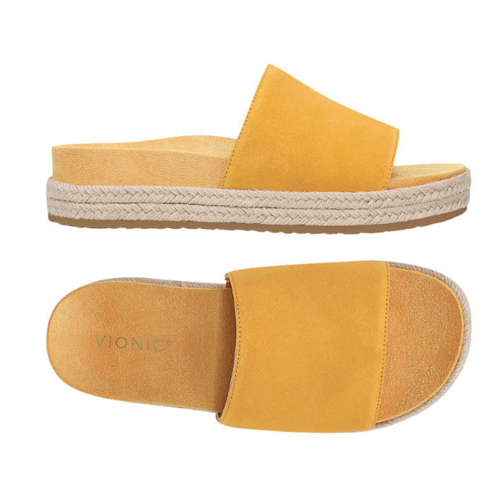 Pair of amber yellow suede slide espadrille sandals with Vionic logo'd tan footbed.