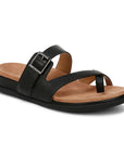 Black strappy sandal with decorative buckle and toe loop criss-cross straps on a tan suede footbed with black rubber outsole.