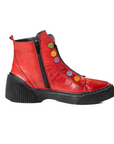 Red leather ankle boots with black platform outsole and inside zipper closure. Multi-coloured buttons run up front of boot.