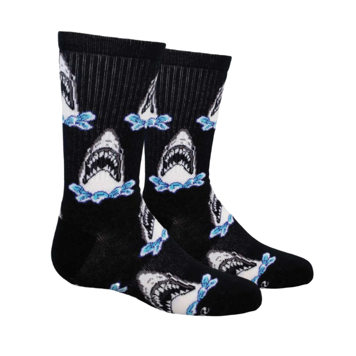 A pair of black crew socks featuring a repeating pattern of white sharks jumping out of water.