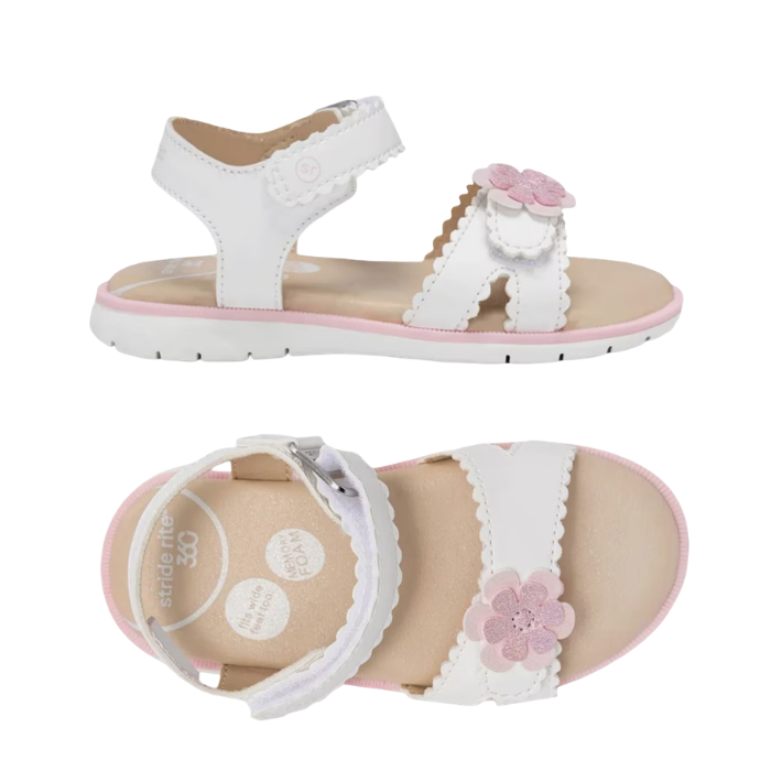 Pair of White kid's backstrap sandals with textured edges on straps, pink 3D flower on toe strap, tan footbed and white outsole.