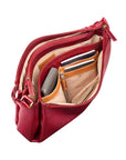 Inside view of red leather handbag with lots of storage space, pocktets, card sleeves and zippers.