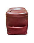 Burgundy leather bucket-style backpack with zippered closure and two zippered pockets on the front and top of bag. 
