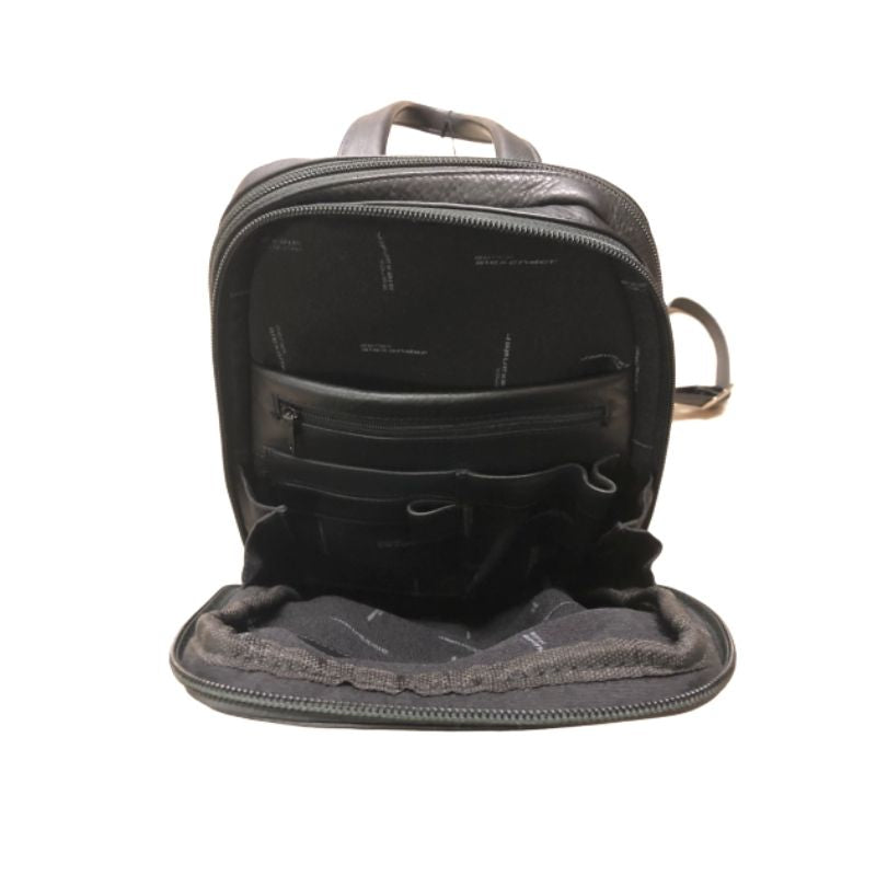 Interior of first compartment of the backpack, displaying zippered pocket and slip pockets. 