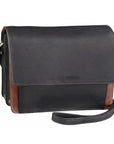 Black with tan accents leather handbag with a flap closure and an adjustable strap by Derek Alexander