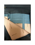 Side flat compartment on black leather bag by Derek Alexander has blue leather card slots.