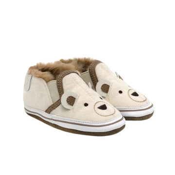Beige baby shoes with polar bears on them.