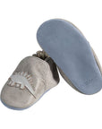 Left shoe shows Grey leather pull on kids shoe with dinosaurs, and right shoe tilted up to show soft blue bottom