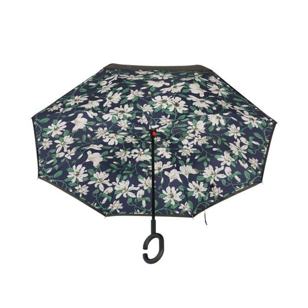 Open Knirps reversible umbrella has c-shaped handle and white flower pattern on navy with green leaf design