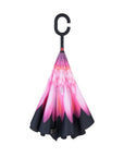 Closed Knirps reversible umbrella has c-shaped handle with pink flower on centre and black edges