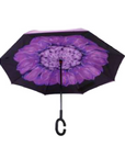 Open Knirps reversible umbrella has c-shaped handle with purple flower from centre with black edges