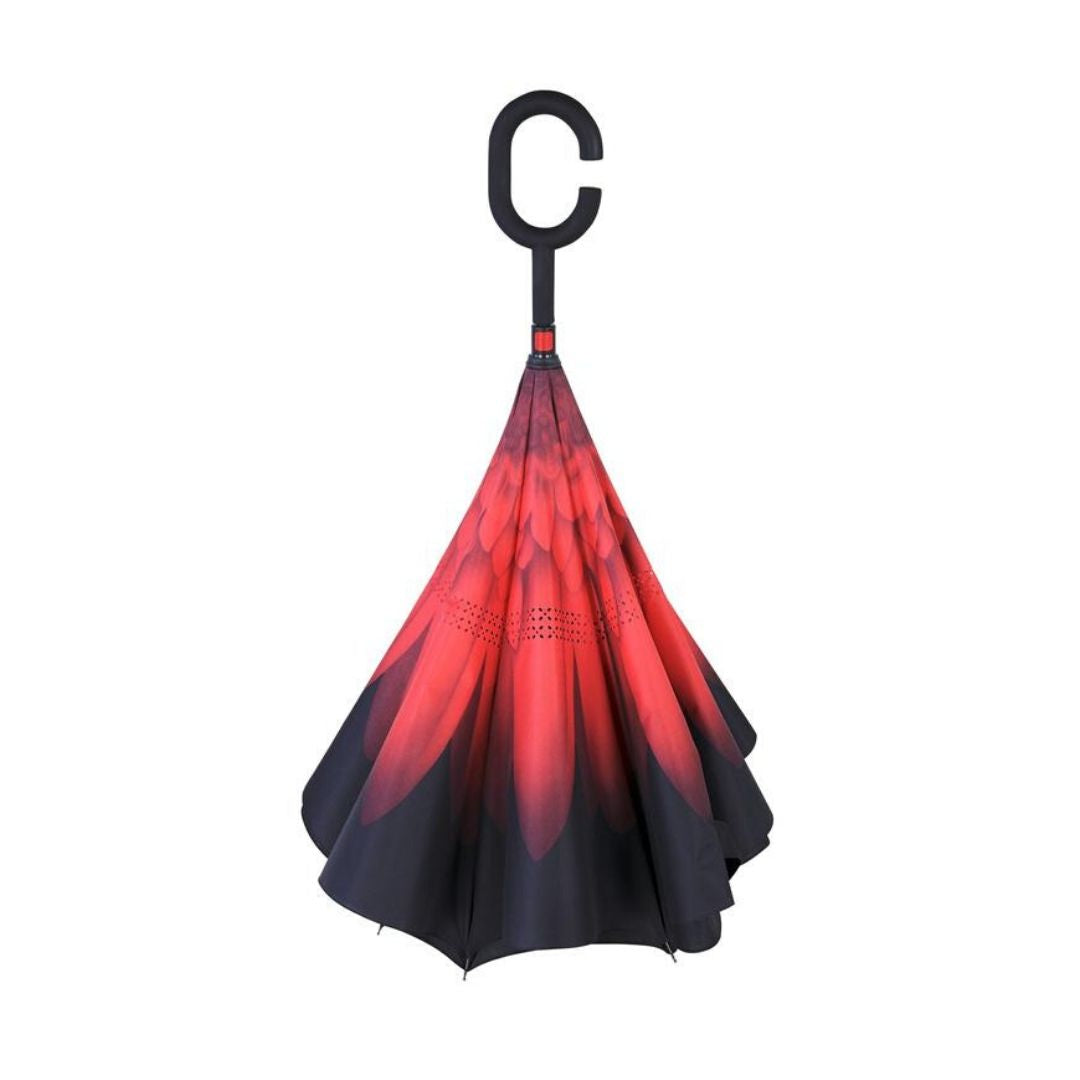Closed Knirps reversible umbrella has c-shaped handle with red flower from centre with black edges
