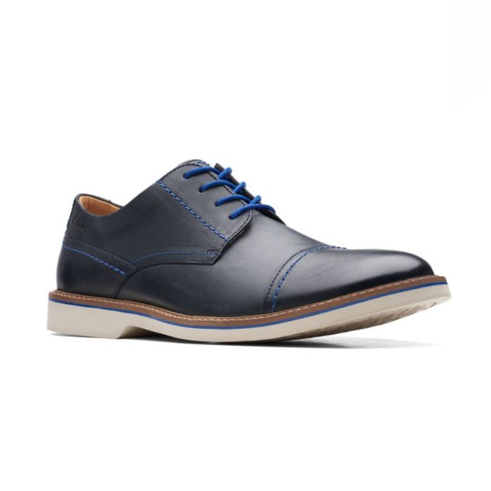 Navy leather dress shoes with bright blue laces, blue stitching and off white outsole.