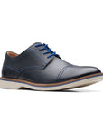 Navy leather dress shoes with bright blue laces, blue stitching and off white outsole.