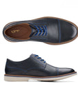 Top and side view of navy leather dress shoes with bright blue laces, blue stitching and off white outsole. Clarks logo on heel of insole.