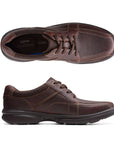 Top and side view of brown leather lace up shoe. Clarks logo on insole of heel.