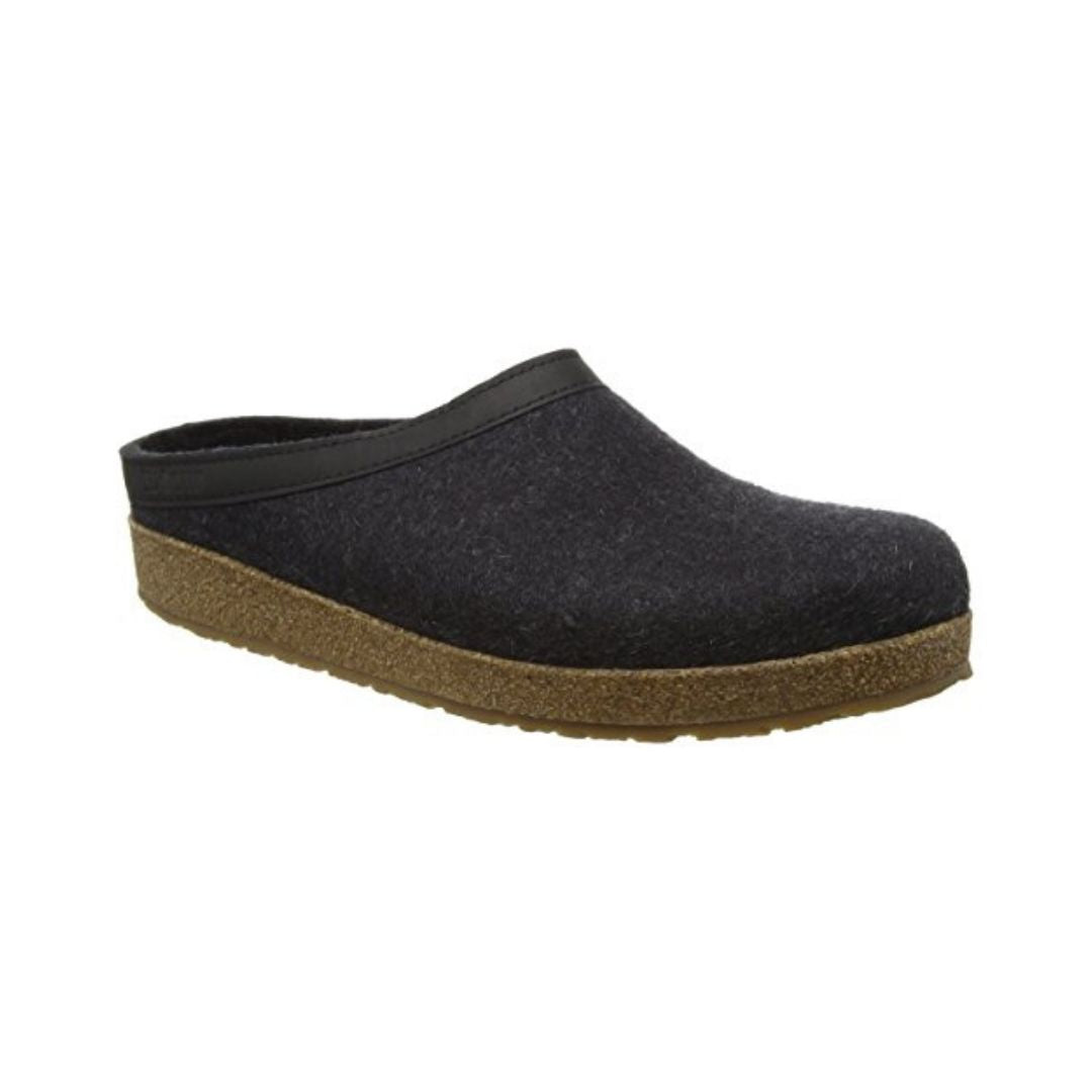 Black wool slide slipper with leather band and Haflinger tag on outside. Cork midsole and brown outsole.